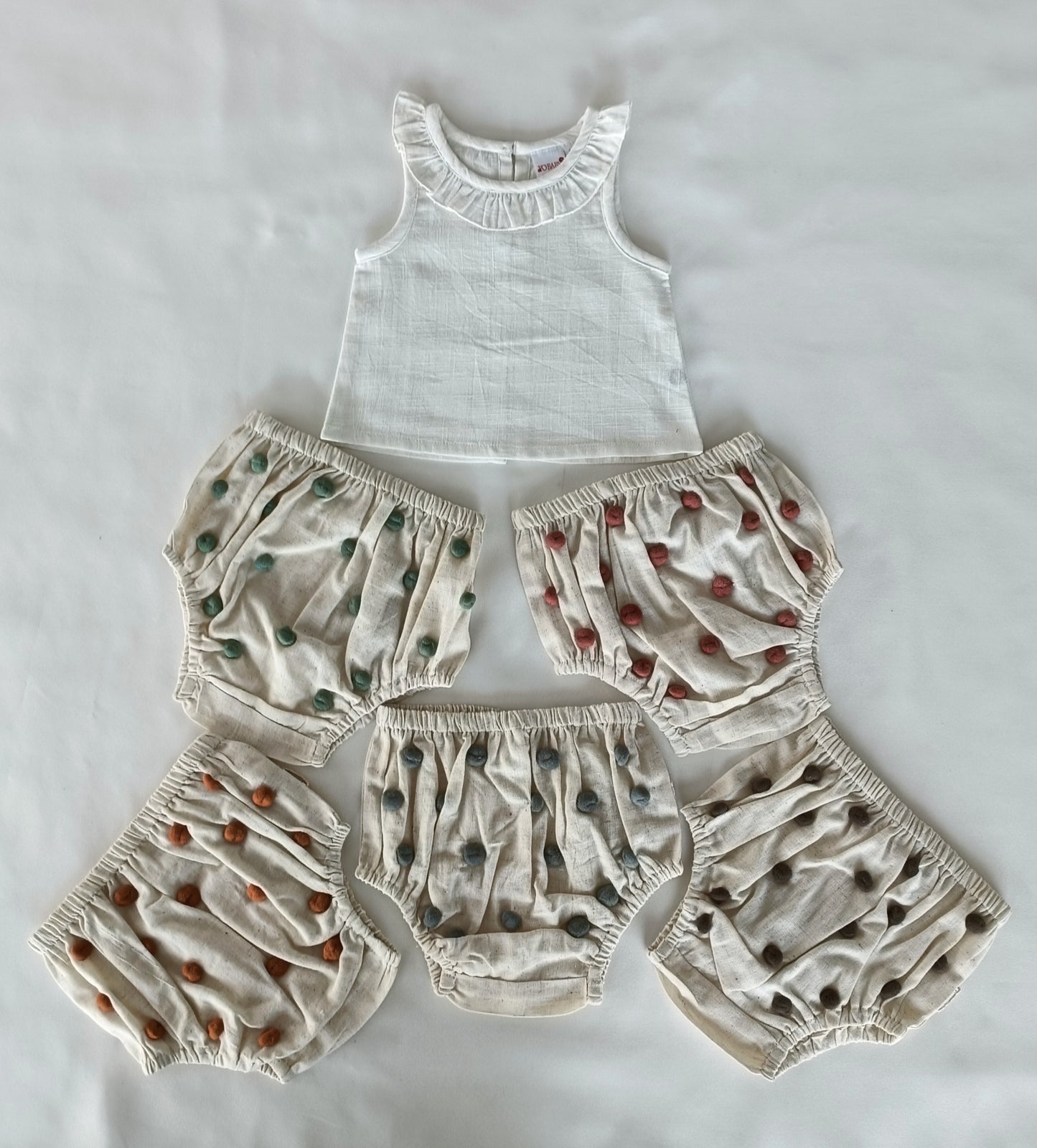 White Ruffle Neck Top & Ivory Diaper Cover With Pom-Poms