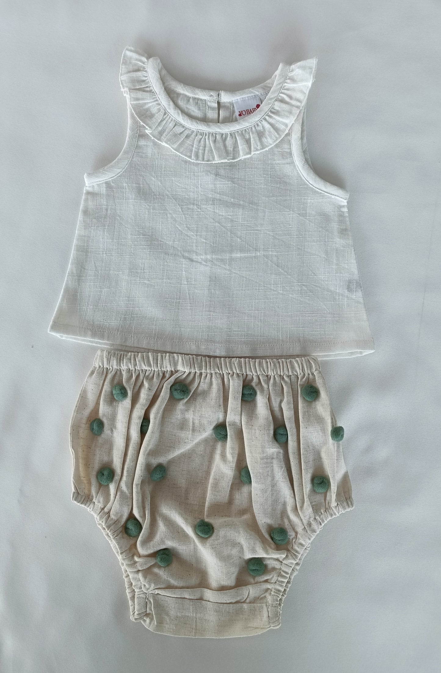 White Ruffle Neck Top & Ivory Diaper Cover With Pom-Poms