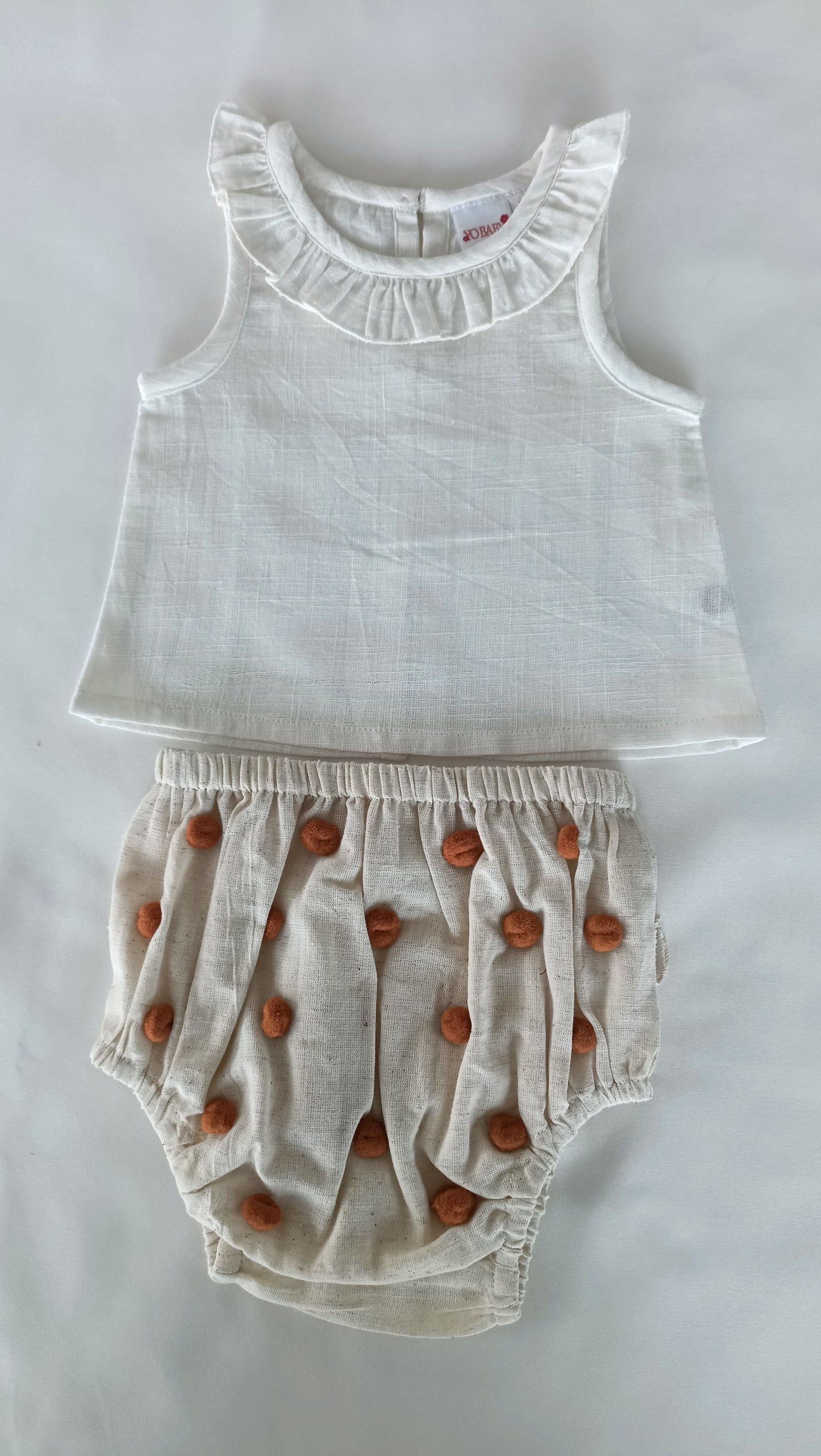White Ruffle Neck Top & Ivory Diaper Cover With Pom-Poms